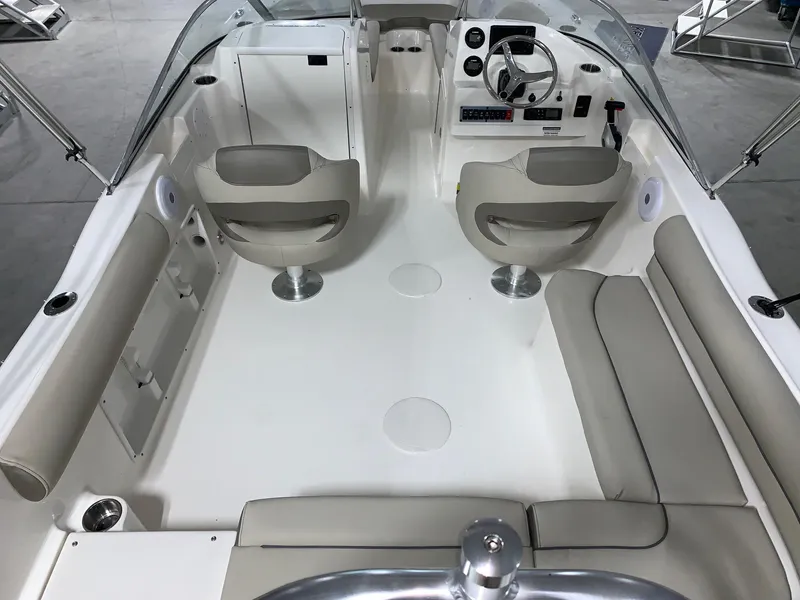 Slide: The Image of 2024 Key West 203 DFS boat interior with seating and steering console. - 14