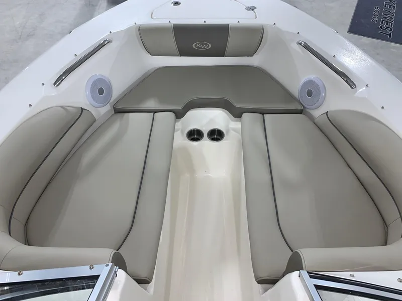 Slide: The Image of 2024 Key West 203 DFS boat interior with cushioned seating and cup holders. - 3