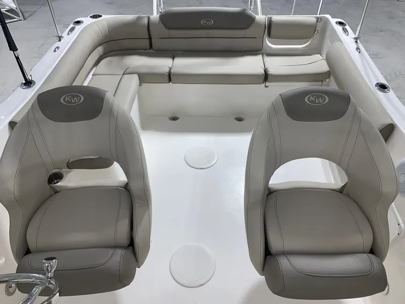 Slide: The Image of 2024 Key West 203 DFS boat interior with beige seating and dual captain chairs. - 5