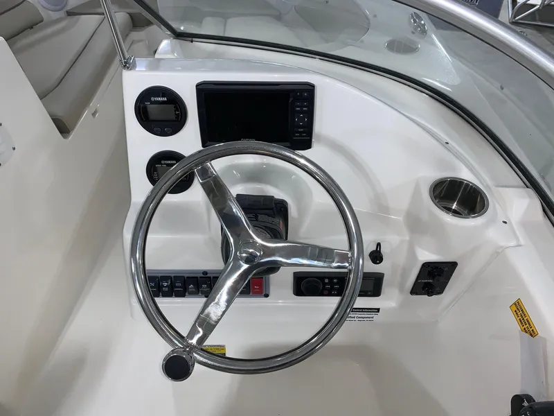 Slide: The Image of 2024 Key West 203 DFS boat dashboard with steering wheel and control panel. - 7