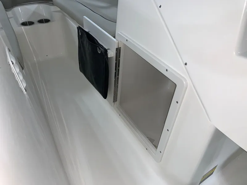 Slide: The Image of 2024 Key West 203 DFS boat interior storage compartment and cup holders. - 10