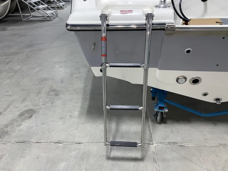 Slide: The Image of 2024 Key West 203 DFS boat with a stainless steel swim ladder. - 2