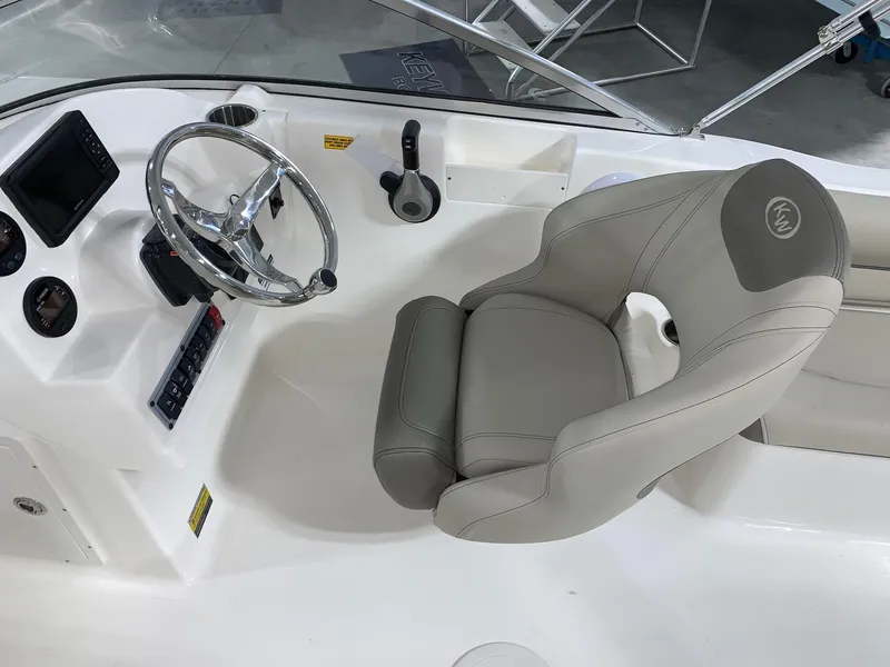 Slide: The Image of 2024 Key West 203 DFS boat cockpit with steering wheel and captain's chair. - 7