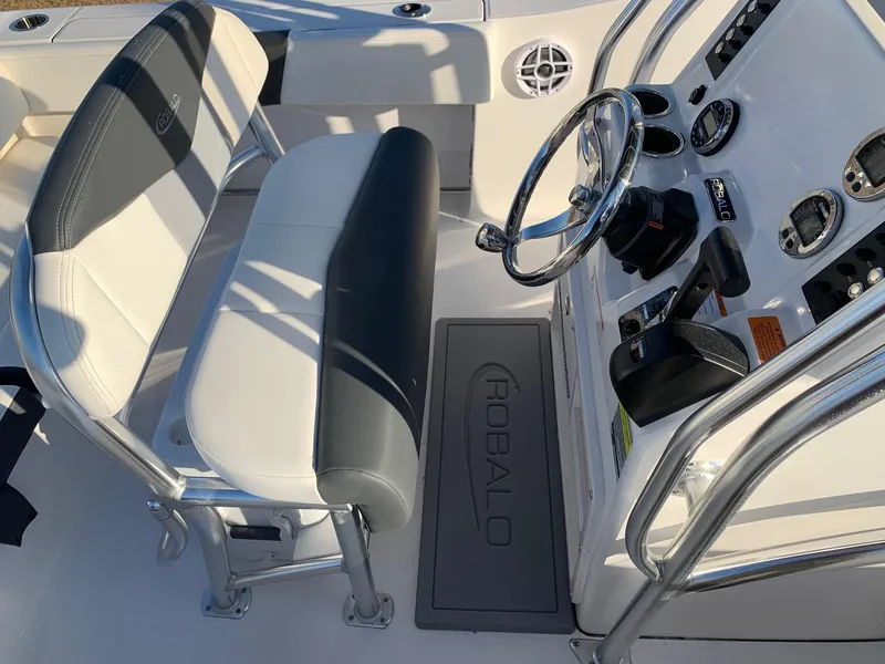 Slide: The Image of 2024 Robalo R202 Explorer boat interior with steering console and seating. - 10
