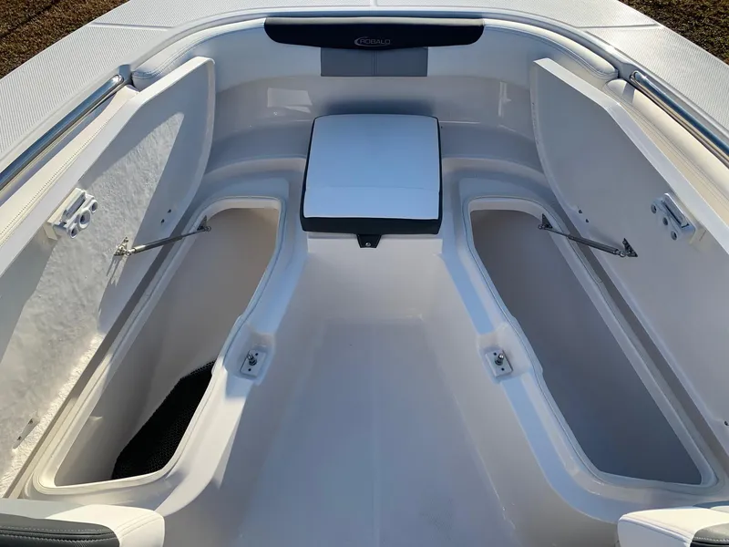 Slide: The Image of 2024 Robalo R202 Explorer boat interior with open storage compartments. - 14