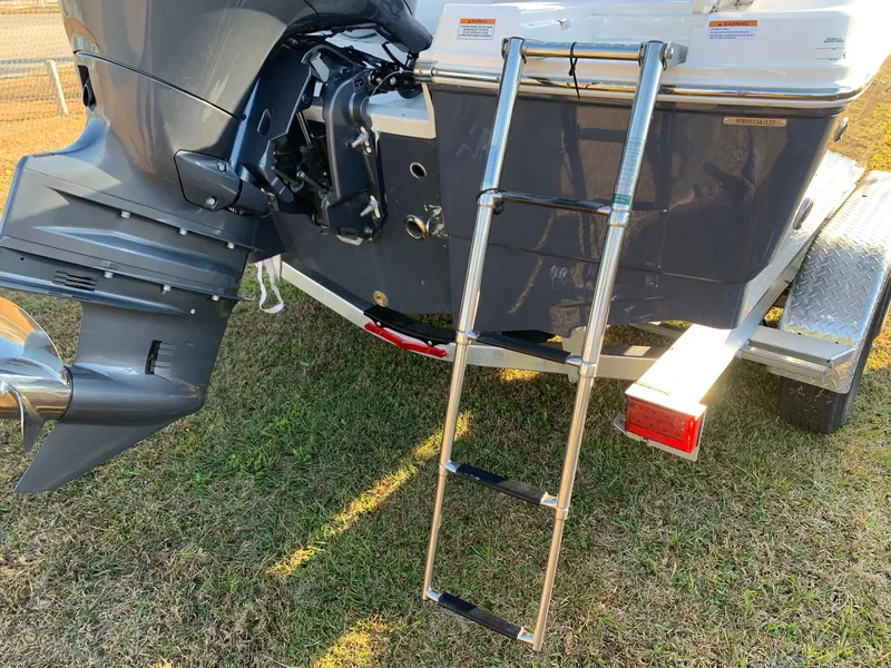 Slide: The Image of 2024 Robalo R202 Explorer boat with ladder and outboard motor. - 5