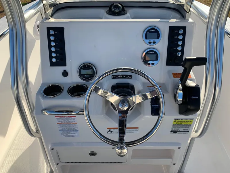 Slide: The Image of 2024 Robalo R202 Explorer boat dashboard with steering wheel and control panel. - 8