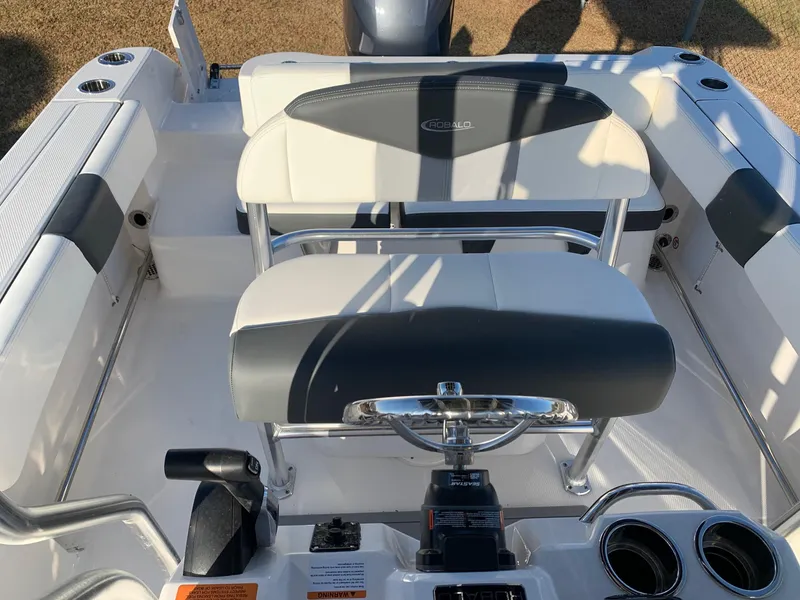 Slide: The Image of 2024 Robalo R202 Explorer boat interior with dual seating and control console. - 11