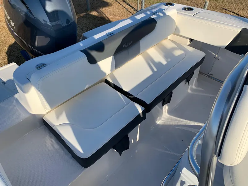 Slide: The Image of 2024 Robalo R202 Explorer boat seating area with white cushioned seats. - 9