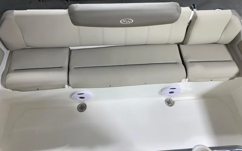 Slide: The Image of 2024 Key West 219 FS boat seating area with cushioned bench and speakers. - 10