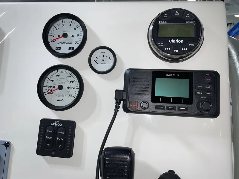Slide: The Image of Key West 219 FS 2024 boat dashboard with gauges, Garmin display, and Clarion audio system. - 12