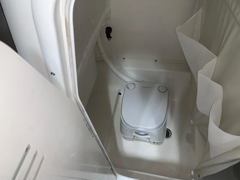 Slide: The Image of 2024 Key West 219 FS boat interior with portable toilet. - 16