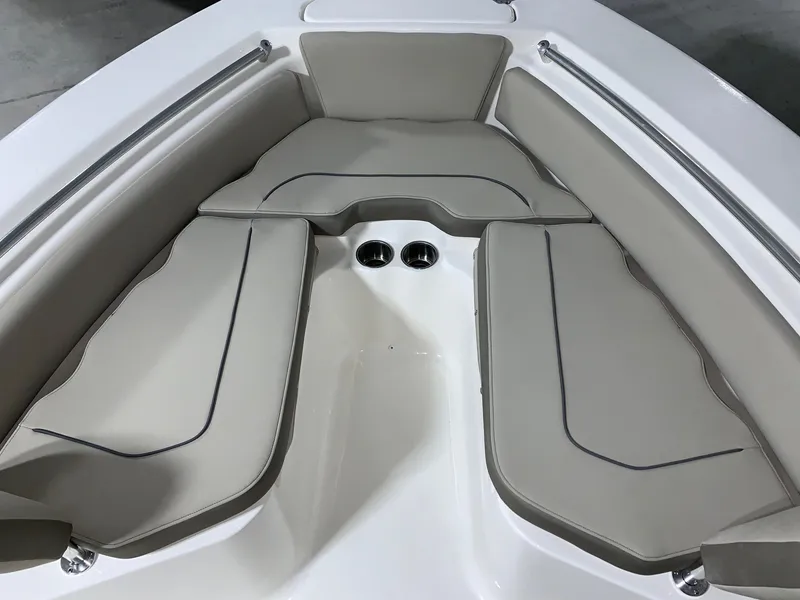 Slide: The Image of 2024 Key West 219 FS boat with cushioned bow seating and cup holders. - 24