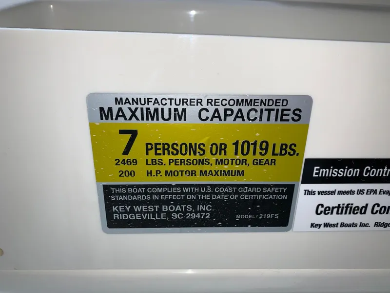 Slide: The Image of 2024 Key West 219 FS boat capacity label: 7 persons or 1019 lbs, 200 HP motor max. - 27