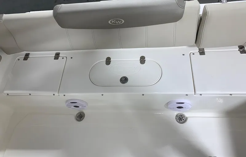 Slide: The Image of 2024 Key West 219 FS boat interior with storage compartments and speakers. - 9