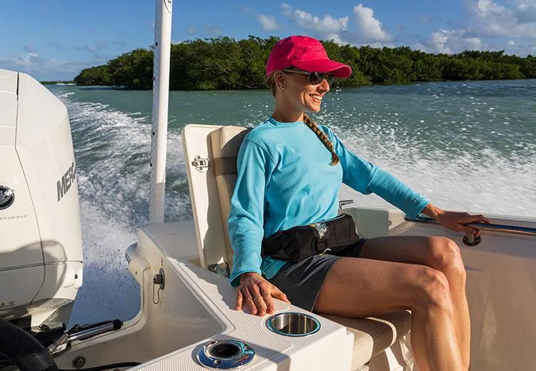 Slide: The Image of Woman enjoying a ride on a 2023 Boston Whaler 220 Dauntless boat. - 3