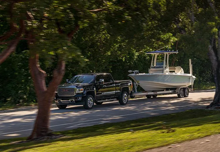 Slide: The Image of Black truck towing 2023 Boston Whaler 220 Dauntless boat on a trailer. - 6