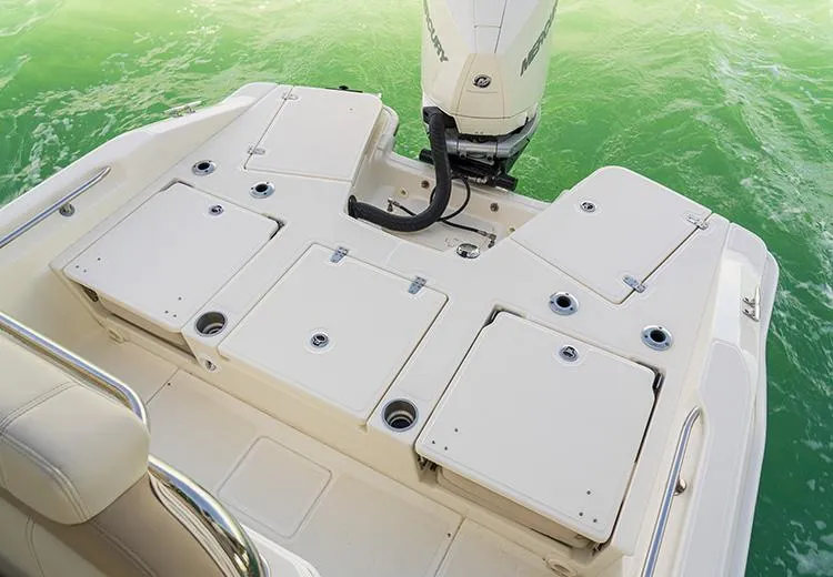 Slide: The Image of 2023 Boston Whaler 250 Dauntless boat stern with storage compartments and outboard motor. - 7