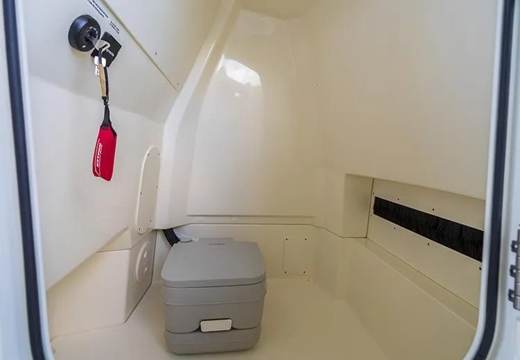 Slide: The Image of 2023 Boston Whaler 250 Dauntless interior storage compartment with portable toilet. - 8