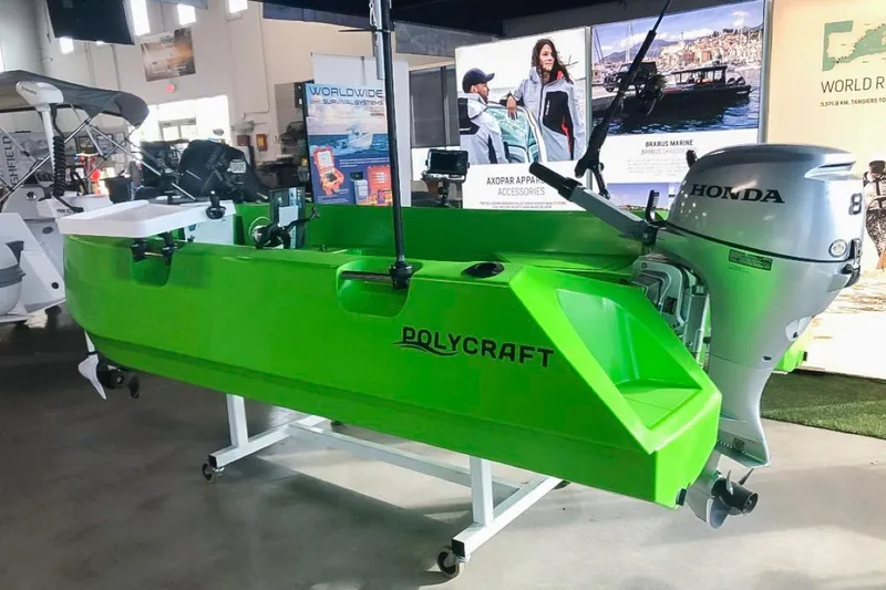 Slide: The Image of Bright green 2021 Polycraft 300 Tuffy boat with Honda outboard motor displayed indoors. - 3