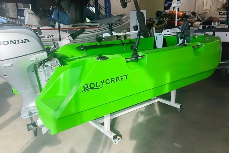 Slide: The Image of Bright green 2021 Polycraft 300 Tuffy boat with Honda motor in showroom. - 4