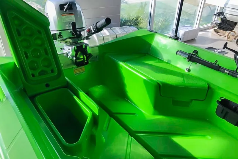 Slide: The Image of Bright green interior of 2021 Polycraft 300 Tuffy boat with storage compartments. - 6