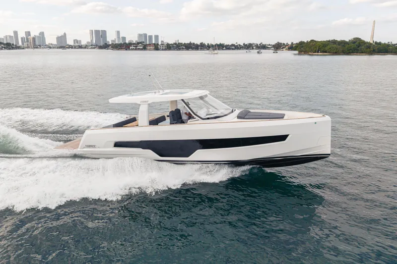 The Image of 2024 Fjord 41 XL yacht cruising on water with city skyline in background. - 17