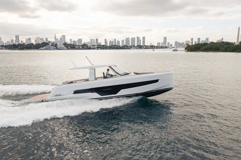 Slide: The Image of 2024 Fjord 41 XL yacht cruising near city skyline on calm waters. - 20