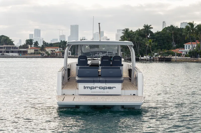 Slide: The Image of 2024 Fjord 41 XL yacht on water, city skyline and palm trees in background. - 27