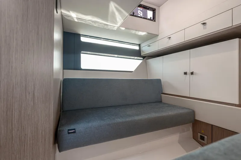 Slide: The Image of 2024 Fjord 41 XL interior cabin with modern seating and storage cabinets. - 48