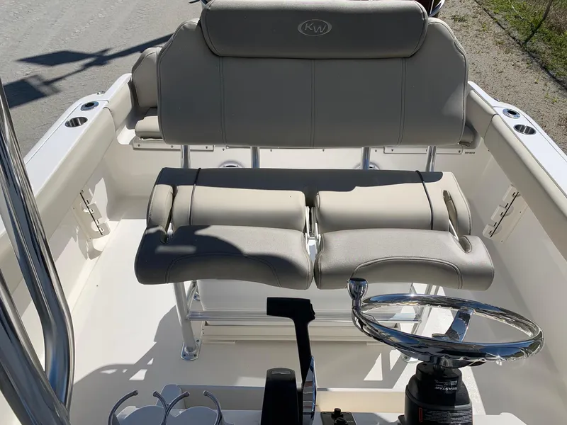 Slide: The Image of 2024 Key West 219 FS boat interior with dual seating and steering wheel. - 10