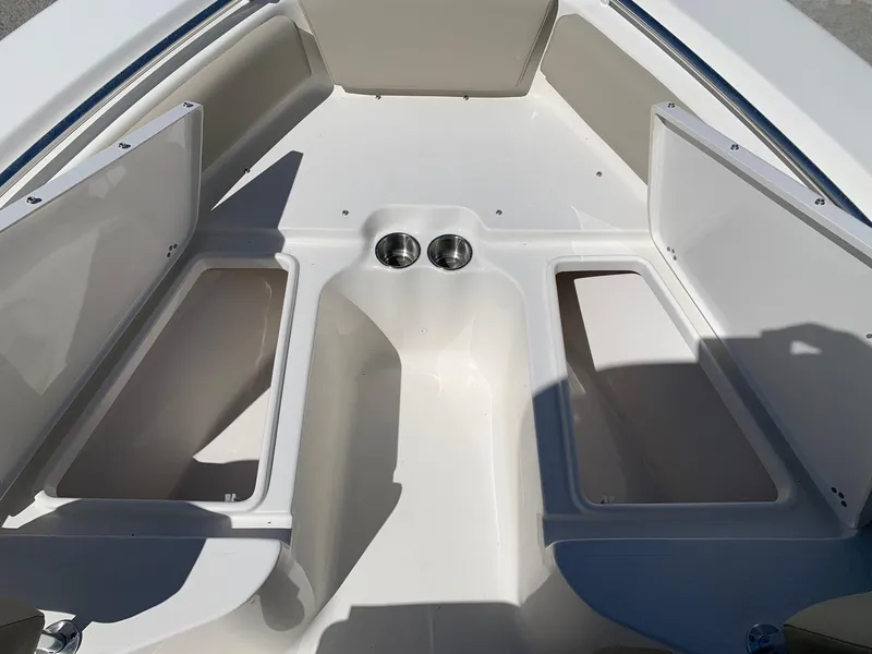 Slide: The Image of 2024 Key West 219 FS boat interior with storage compartments and cup holders. - 13