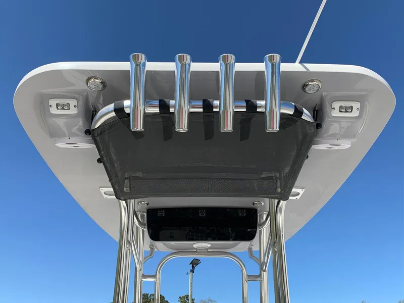 Slide: The Image of 2024 Key West 219 FS boat T-top with rod holders against blue sky. - 4