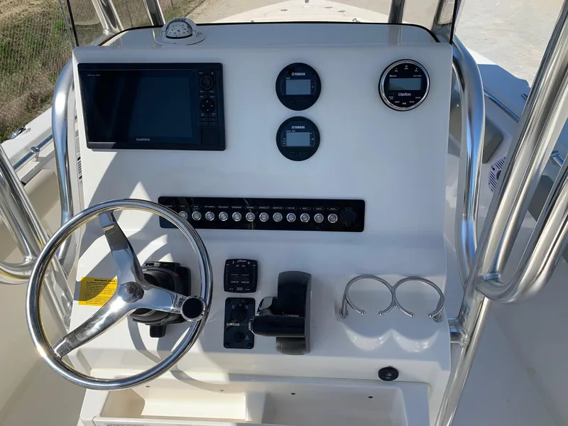 Slide: The Image of 2024 Key West 219 FS boat console with steering wheel, gauges, and controls. - 5