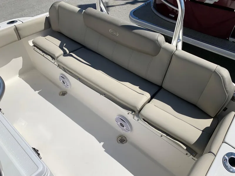 Slide: The Image of 2024 Key West 219 FS boat with beige seating and built-in speakers. - 8