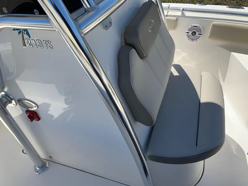 Slide: The Image of 2024 Key West 219 FS boat interior with cushioned seating and speaker. - 14