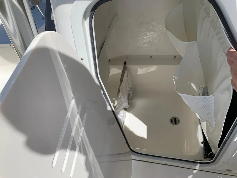 Slide: The Image of 2024 Key West 219 FS boat storage compartment with open hatch. - 7
