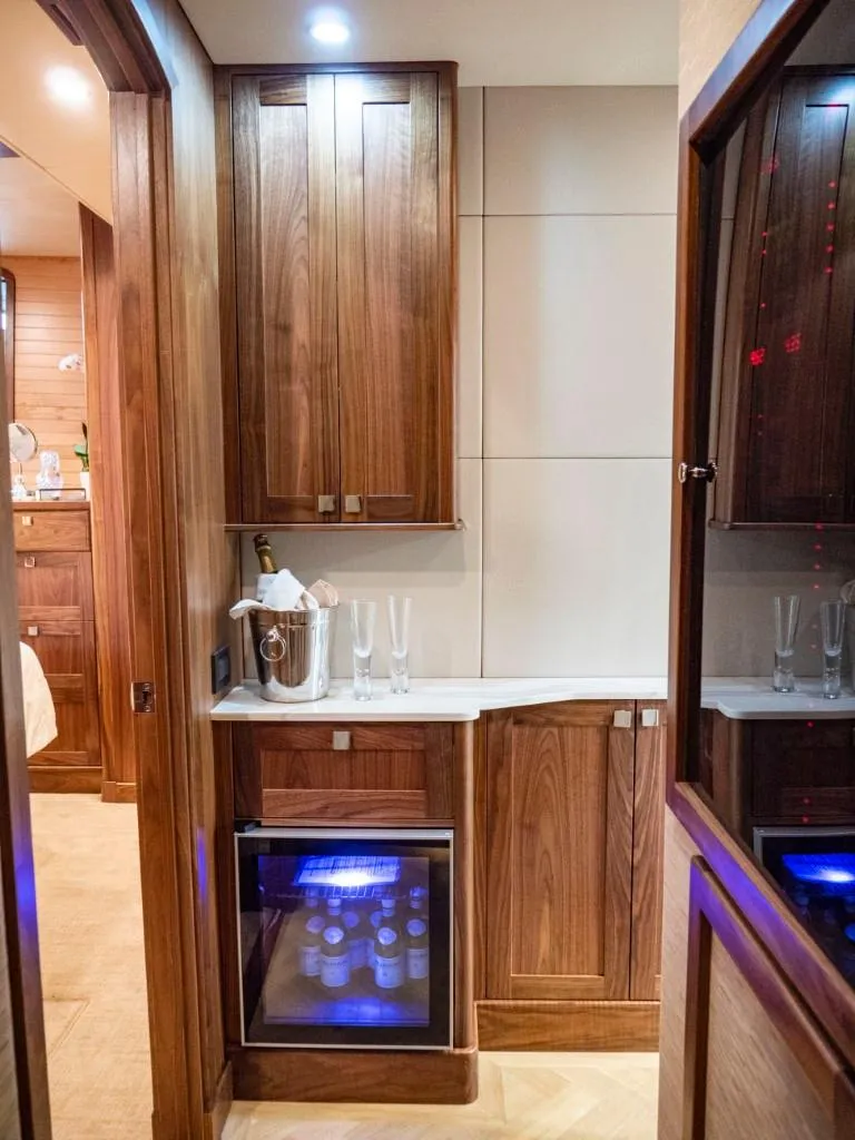 Slide: The Image of Luxurious kitchenette in 2025 Northern Marine 57 Expedition yacht with wooden cabinetry and mini-fridge. - 10