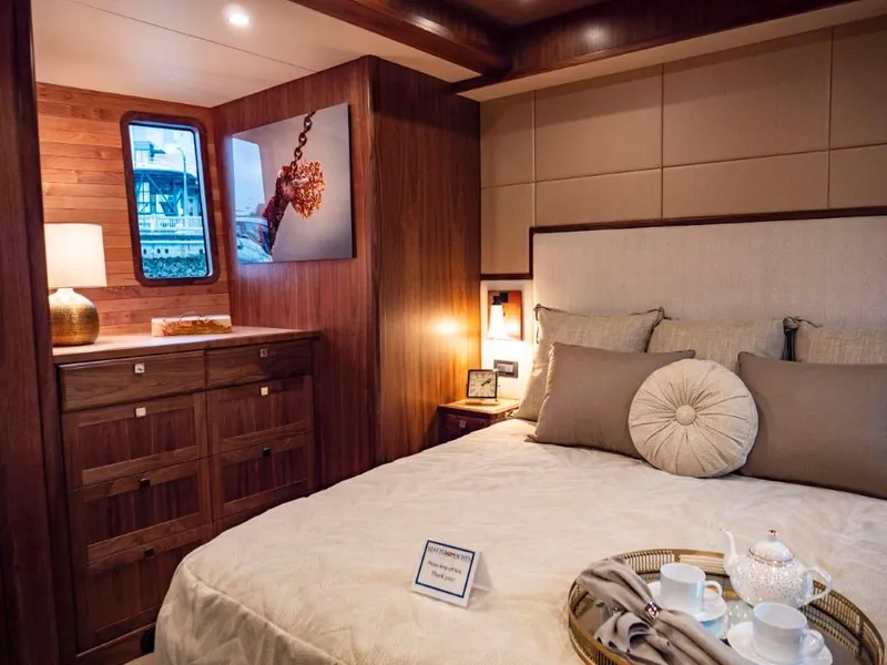 Slide: The Image of Luxurious bedroom in 2025 Northern Marine 57 Expedition yacht with elegant decor. - 12