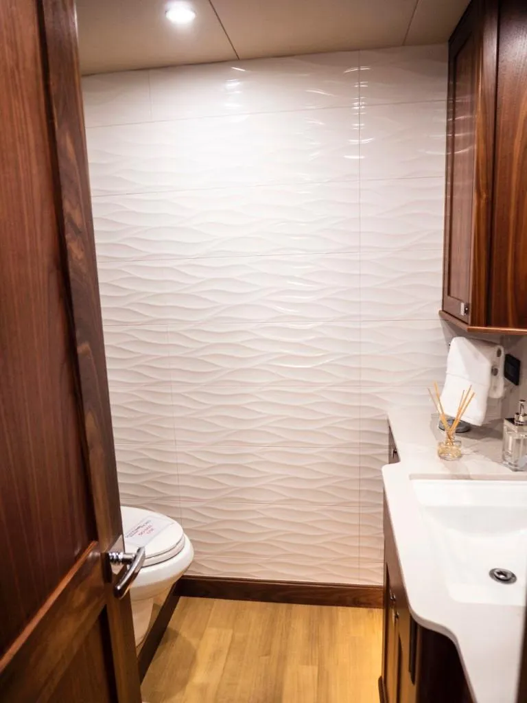 Slide: The Image of Modern bathroom in 2025 Northern Marine 57 Expedition yacht with wood accents and white textured wall. - 15