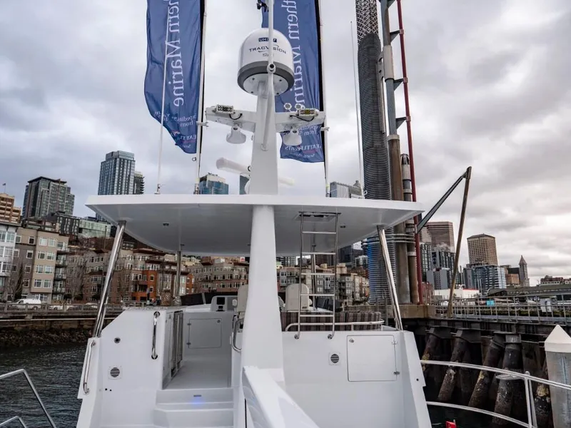 Slide: The Image of Northern Marine 57 Expedition 2025 yacht docked in urban marina with city skyline. - 42