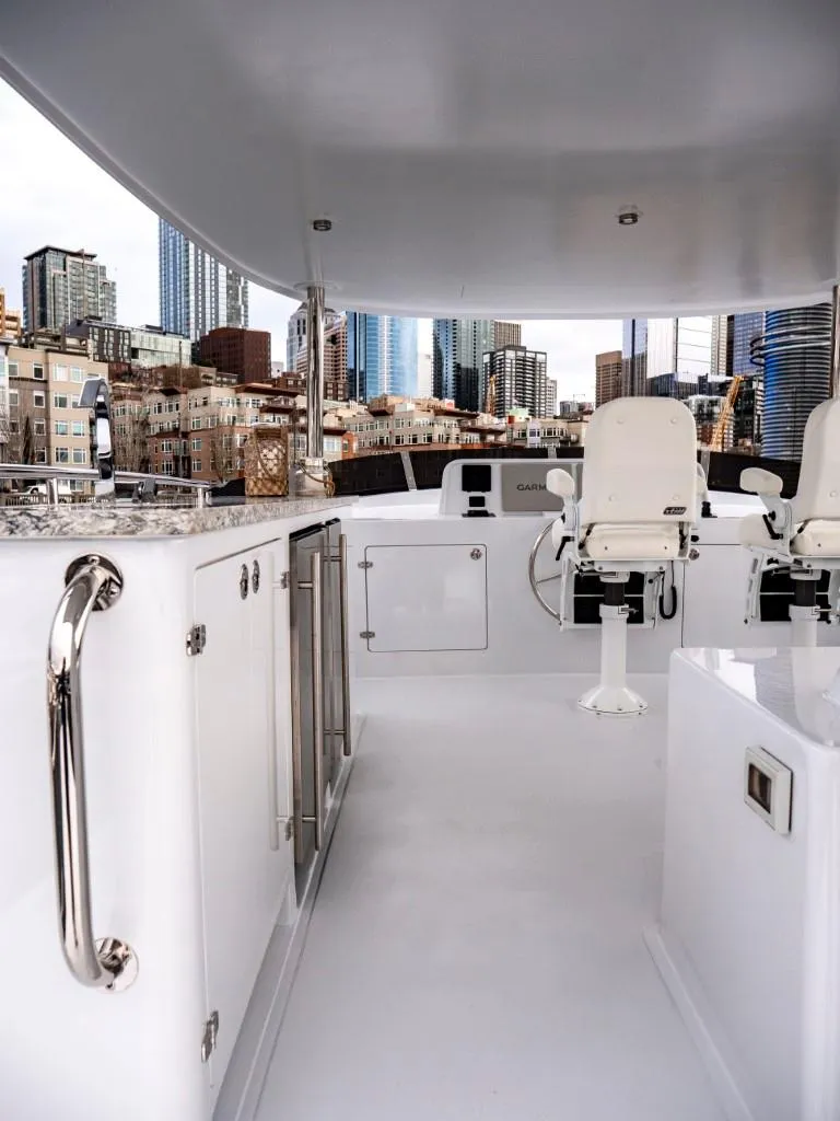 Slide: The Image of 2025 Northern Marine 57 Expedition yacht deck with city skyline in the background. - 43