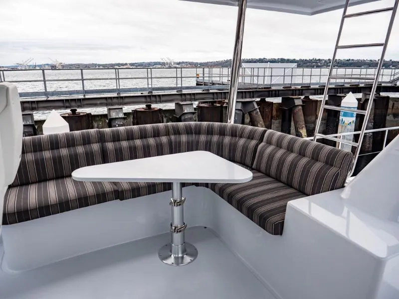 Slide: The Image of Northern Marine 57 Expedition 2025 yacht with striped seating and table on deck. - 45