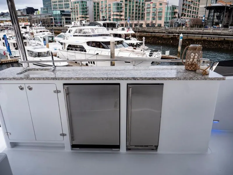 Slide: The Image of Outdoor kitchen on 2025 Northern Marine 57 Expedition yacht, docked at marina. - 46