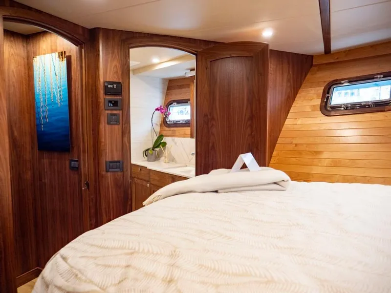 Slide: The Image of Luxurious cabin interior of 2025 Northern Marine 57 Expedition yacht with wooden finishes and modern amenities. - 7