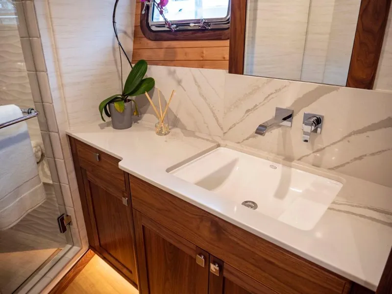 Slide: The Image of Luxurious bathroom in 2025 Northern Marine 57 Expedition yacht with modern sink and wooden cabinetry. - 8