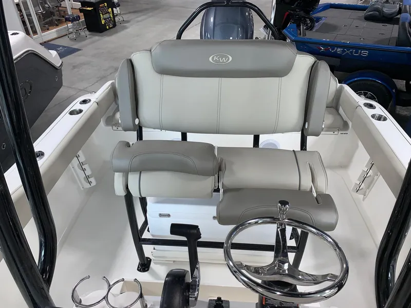 Slide: The Image of 2024 Key West 219 FS boat interior with dual seating and steering wheel. - 12