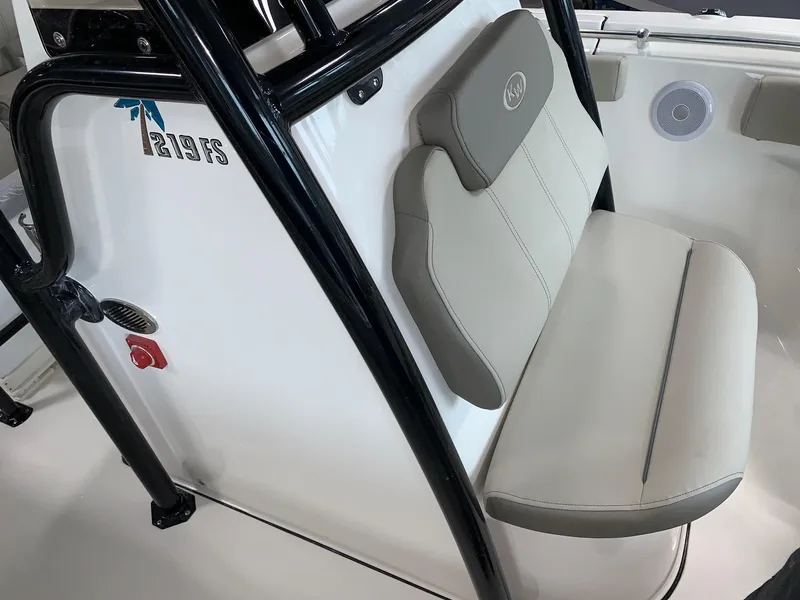 Slide: The Image of 2024 Key West 219 FS boat interior with cushioned seating and black frame. - 13