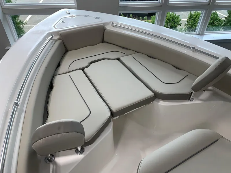 Slide: The Image of 2024 Key West 219 FS boat with cushioned seating area. - 15
