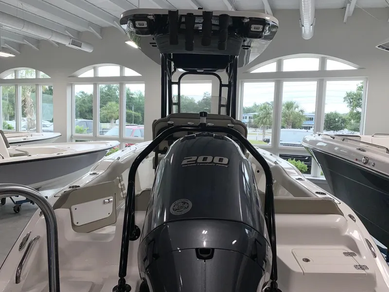 Slide: The Image of 2024 Key West 219 FS boat with a 200 HP engine in a showroom. - 2